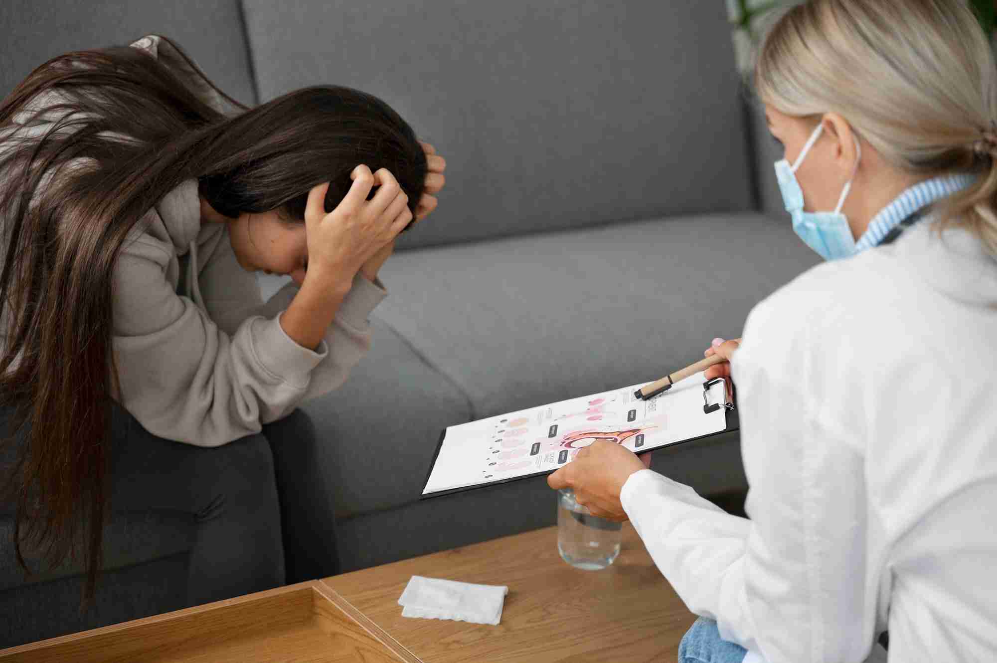 clinical depression a doctor and a young girl on sofa